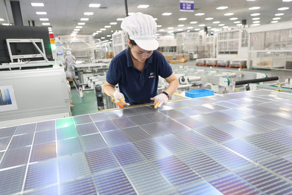 A worker assembles solar panels at a production facility in Lianyungang, China. Credit: Si Wei/VCG via Getty Images