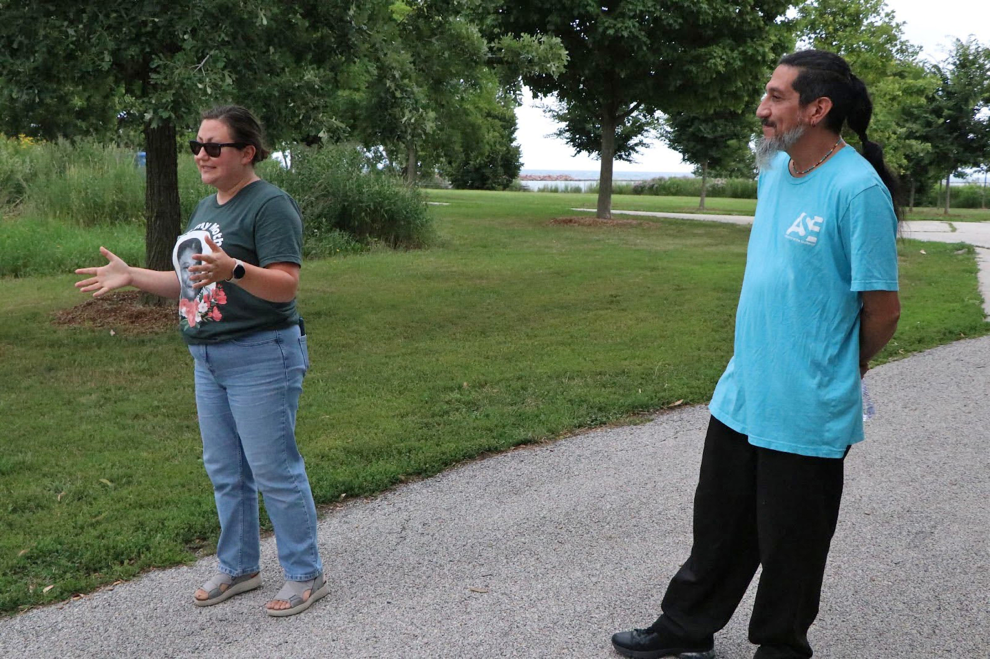 Samuel Corona (right) and Katia Balba give a “toxic tour” at Steelworkers Park in Chicago with their organization, Alliance of the Southeast, on July 17. Credit: Fern Alling/Inside Clean Energy