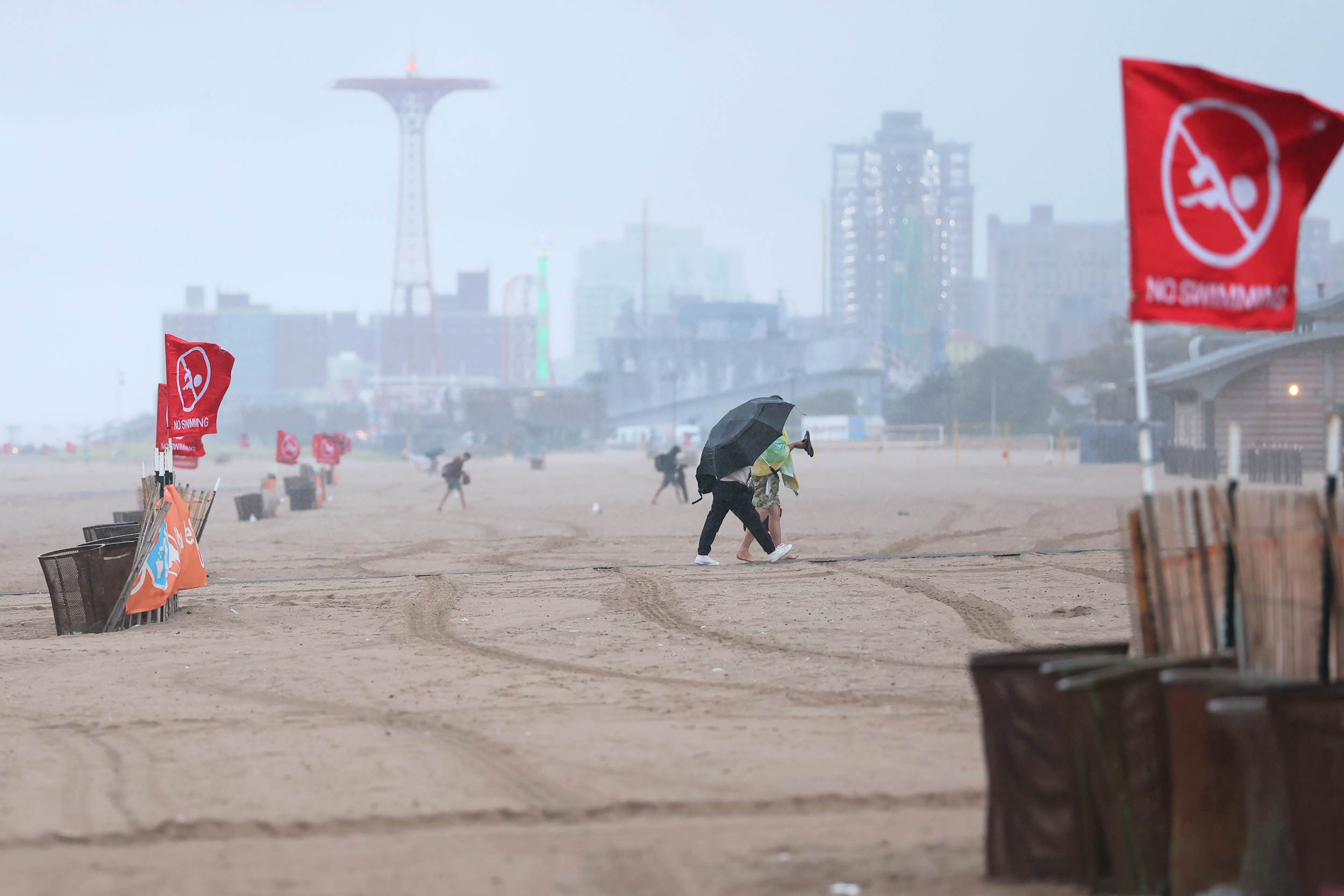 Red “no swimming” flags dot Brighton Beach amid Hurricane Erin on Wednesday in New York City. Credit: Michael M. Santiago/Getty Images