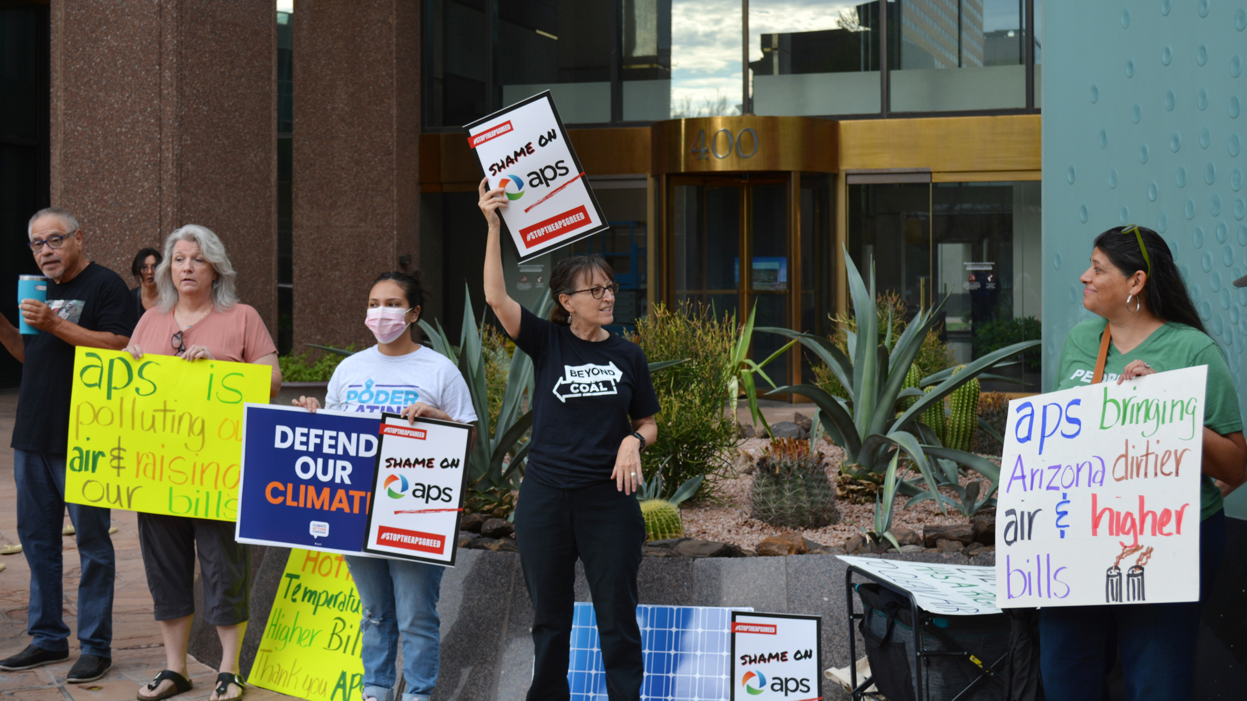 Sandy Bahr (center), the Sierra Club’s Grand Canyon chapter director, speaks during a protest on Thursday over Arizona Power Service’s recent decision to walk back its clean energy goals. Credit: Wyatt Myskow/Inside Climate News