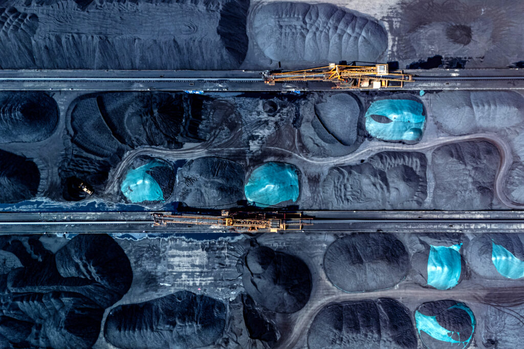 Machinery transfers coal at a port in China’s Chongqing municipality on April 20. Credit: STR/AFP via Getty Images