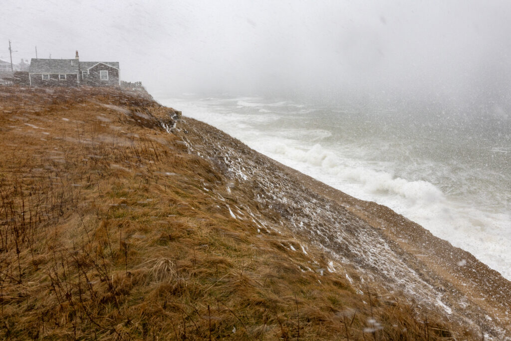 A nor’easter causes large waves to hit a bluff filled with sand to prevent erosion in Nantucket, Mass., on Feb. 13, 2024. Credit: Stan Grossfeld/The Boston Globe via Getty Images