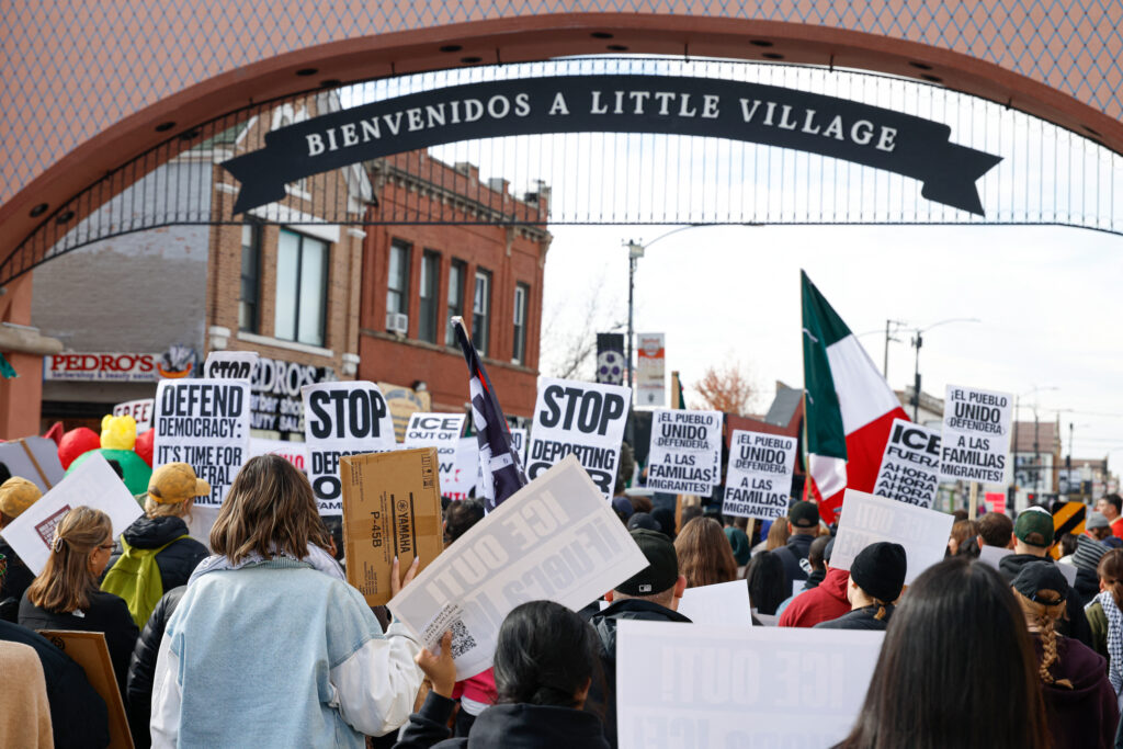 Protesters hold signs against ICE during a demonstration at the predominantly Mexican-American neighborhood of Little Village in Chicago on Oct. 25. Credit: Kamil Krzaczynski/AFP via Getty Images