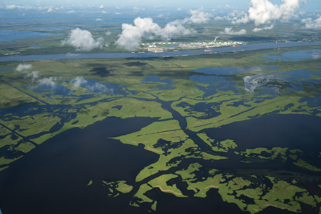 Coastal waters flow through deteriorating wetlands in Plaquemines Parish, Louisiana. Since the 1930s, Louisiana has lost over 2,000 square miles of land, an area roughly the size of Delaware, partially due to climate-driven sea level rise. Credit: Drew Angerer/Getty Images