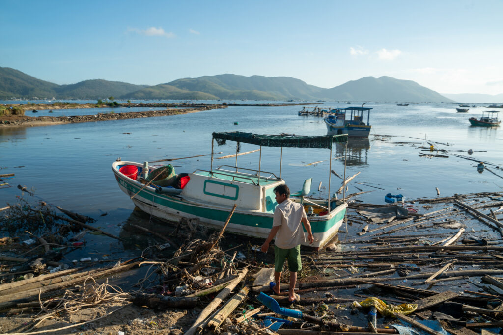 At Xuan Dao Bay, in Vietnam, fishing boats lie destroyed in November 2025 along the shore after being swept away by Typhoon Kalmaegi. leaving many without work. Credit: Magdalena Chodownik/Anadolu via Getty Images