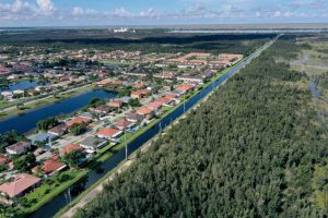 An aerial view of urban sprawl nestled next to protected wetlands on the fringes of Everglades National Park in Miami Dade County, Florida. Credit: Joe Raedle/Getty Images