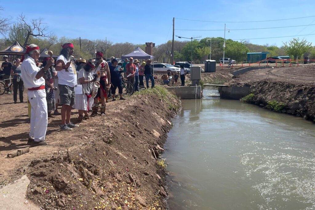 Community members participate in a blessing ceremony of the Atrisco Acequia Madre in Albuquerque, N.M. Credit: Tina Deines/Inside Climate News