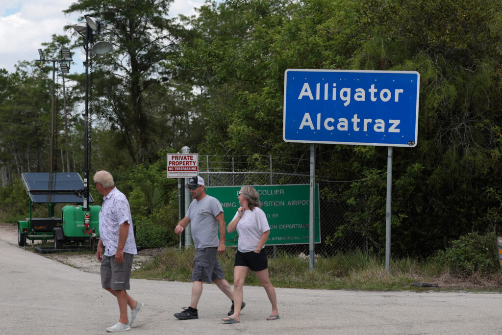 People walk near the front entrance to Alligator Alcatraz in the Florida Everglades on April 22. Credit: Joe Raedle/Getty Images
