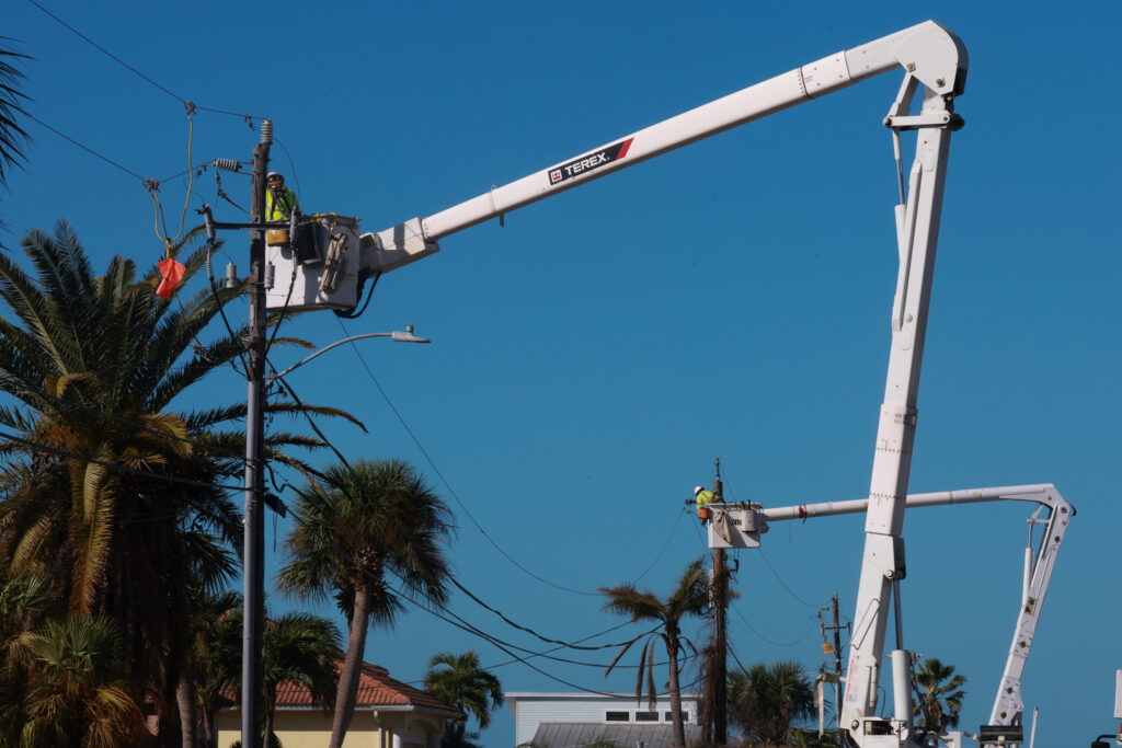 Utility workers repair power lines after Hurricane Milton passed through the area on Oct. 12, 2024, in Englewood, Fla. Credit: Joe Raedle/Getty Images