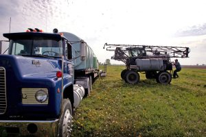 A farmer loads herbicide into a sprayer to be applied to a corn field near Rochelle, Ill. Credit: Scott Olson/Getty Images