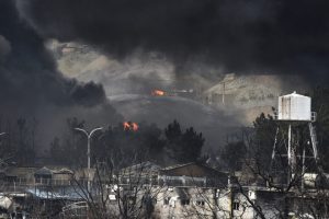 Plumes of smoke rise over oil depot tanks hit by a joint Israel-U.S. attack on March 8 in Tehran, Iran. Credit: Kaveh Kazemi/Getty Images