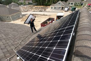 Solar panels are installed on the roof of a home at a housing development in Falmouth, Maine. Credit: Ben McCanna/Portland Portland Press Herald via Getty Images