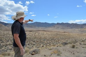 Bernard Rowe, managing director of Ioneer, points to the site of the company’s planned lithium mine on Nevada’s Rhyolite Ridge. Credit: Wyatt Myskow/Inside Climate News
