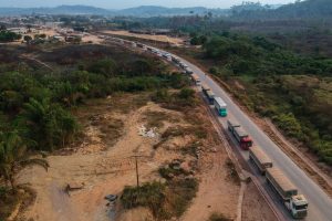 Trucks drive along the BR-163 highway through the Amazon rainforest in Pará, Brazil. Credit: Nelson Almeida/AFP via Getty Images