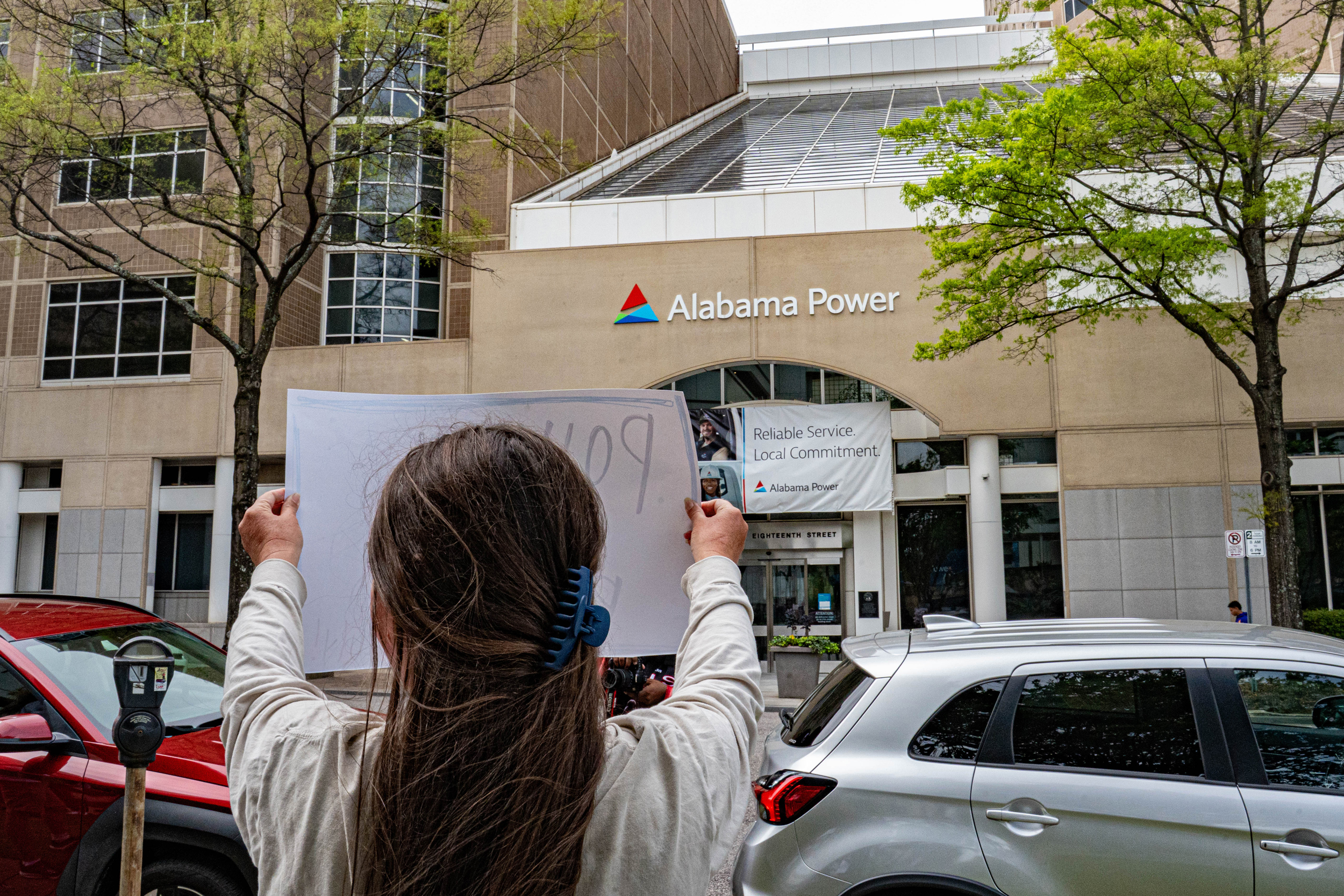 Um manifestante segura uma placa em frente à sede da Alabama Power em Birmingham após a aprovação da lei de reestruturação do PSC. Crédito: Lee Hedgepeth/Naturlink