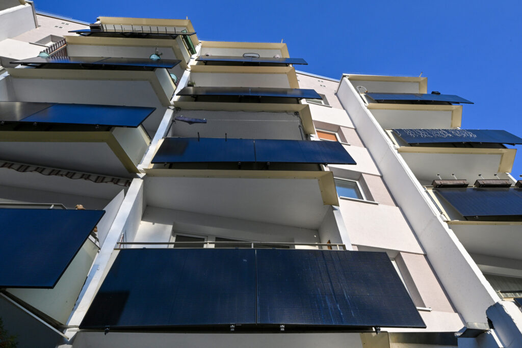 Plug-in solar panels sit on the balconies of a building in Erfurt, Germany. Credit: Martin Schutt/picture alliance via Getty Images