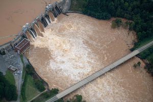 Muddy flood waters of the Catawba River pour over the Oxford Dam, threatening a highway bridge in the aftermath of Hurricane Helene on Sept. 28, 2024, in Hickory, N.C. Credit: Steve Exum/Getty Images