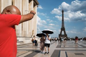 People walk through Place du Trocadéro during the second major heat wave of the year in Paris on June 18. Credit: Jerome Gilles/NurPhoto via Getty Images