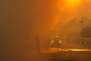 Firefighters are barely visible as smoke from the Bain Fire fills the air on May 19 in Jurupa Valley, Calif. Credit: Gina Ferazzia/Los Angeles Times via Getty Images