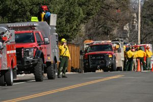 Wildland firefighters stage on Baseline Road in Boulder, Colo., as a helicopter crew works to battle a fire near Chautauqua on Feb. 28. Credit: Matthew Jonas/MediaNews Group/Boulder Daily Camera via Getty Images