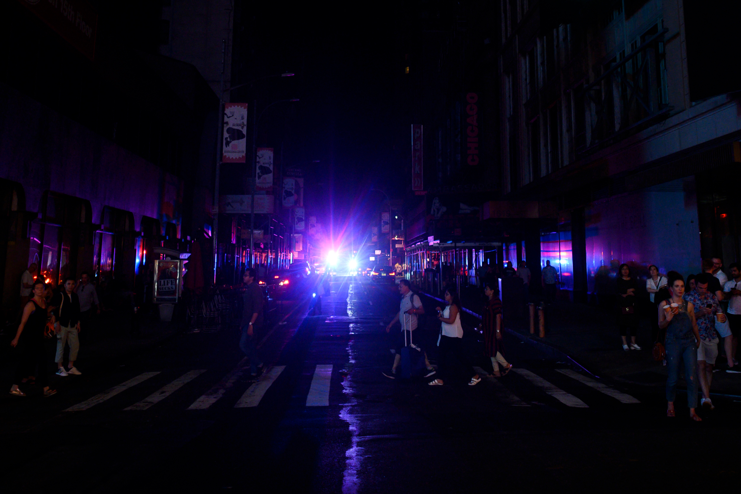 People walk around Manhattan during a power outage in New York City on July 13, 2019. Credit: Johannes Eisele/AFP via Getty Images
