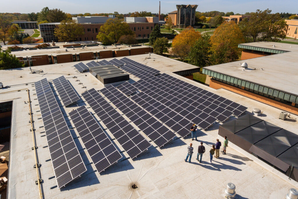 A worker explains the features of a commercial rooftop solar project that was installed by GAI Energy of Flora, Ind. Credit: GAI Energy