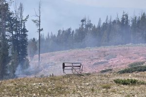 Smoke rises around the burned chairs at Maverick Mountain in Montana after the Sand Creek Fire damaged the ski area. Credit: Maverick Mountain Resort
