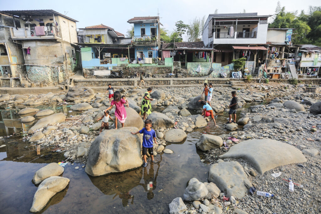 Children play in the shrinking waters of the Ciliwung River in Bogor, Indonesia, on July 27 amid drought conditions intensified by this year’s El Niño. Credit: Agoes Rudianto/Anadolu via Getty Images