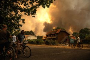 Smoke rises behind a residential area as a wildfire burns in Gironde, France, on July 23, 2026. New research suggests that dangerous conflagrations like the Gironde wildfire will become more common in the future. Credit: Julien De Rosa/AFP via Getty Images