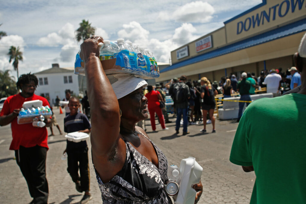 Belle Glade residents receive food and water in the wake of Hurricane Irma on Sept. 13, 2017. Credit: Brian Blanco/Getty Images