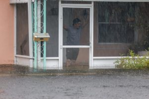 A man looks out at the floodwater surrounding his home on June 12, 2024, in Hollywood, Fla. Credit: Joe Raedle/Getty Images