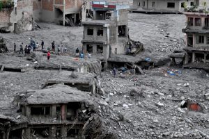People search through debris in the aftermath of flash flooding at Trishuli Center in Nepal’s Nuwakot district on Sept. 1. Credit: Arun Sankar/AFP via Getty Images