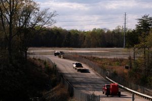 Construction vehicles drive down the road to a proposed data center development in Lusby, Md., on April 6. Credit: Nathan Howard/The Washington Post via Getty Images