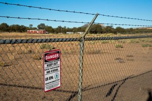 A sign warns of radiation danger at the site of an abandoned uranium mine on Navajo Nation land in Mariano Lake, N.M. Credit: Jim West/UCG/Universal Images Group via Getty Images