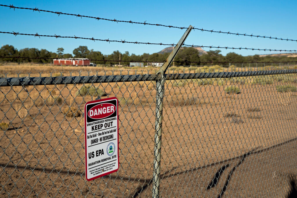 A sign warns of radiation danger at the site of an abandoned uranium mine on Navajo Nation land in Mariano Lake, N.M. Credit: Jim West/UCG/Universal Images Group via Getty Images