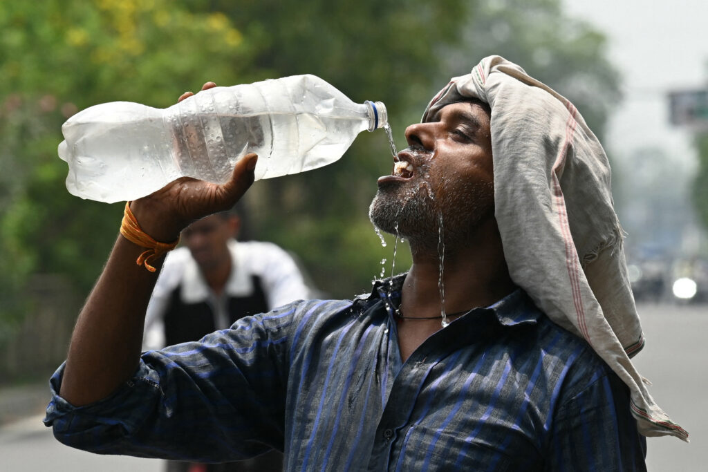 A worker cools off with water during high temperatures in Amritsar, India, on June 29. Credit: Narinder Nanu/AFP via Getty Images