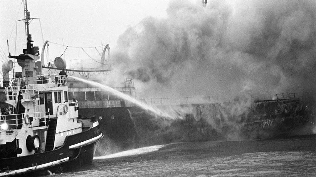 A fire rages on the SS South America, one of at least 90 fires that broke out on ships carrying fishmeal between the 1950s and 1970s. In an effort to prevent more fishmeal fires on cargo ships, the feed industry began treating fishmeal with ethoxyquin. Credit: Sepia Times, NY Daily News, Evers, Joost/Anefo