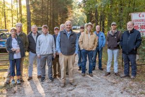 Fenn Church, center, is flanked by supporters at the gate of his property in Shelby County, Alabama. Photo credit: Lee Hedgepeth/ Inside Climate News