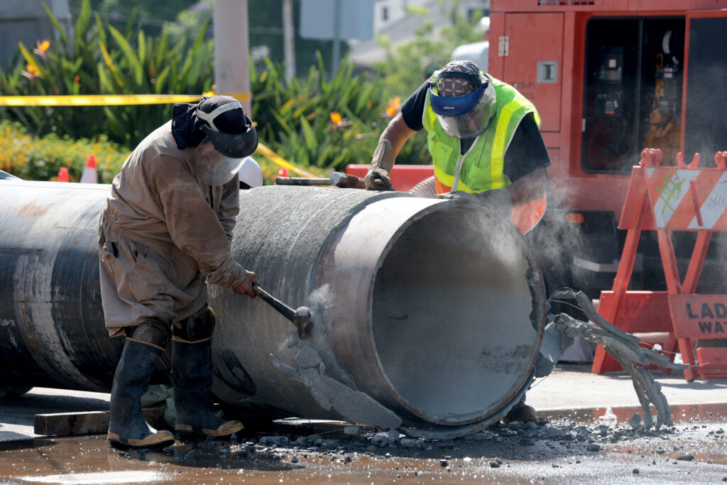 Crews prepare a replacement pipe as they repair a water main in West Hollywood, Calif., on July 17. Credit: Myung J. Chun/Los Angeles Times via Getty Images