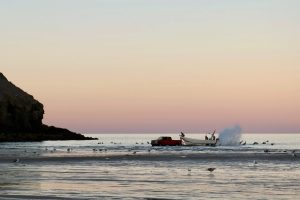 A panga returns at dusk beneath the cliffs of San Felipe’s Shrine of Guadalupe, home to one of the town’s unofficial and largely unregulated fishing slipways. Credit: Ryan Green/Pulitzer Center