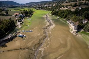 Boats are left stranded on a dried-up river on the border of France and Switzerland during a heatwave in Europe on Aug 11. Credit: Fabrice Coffrini/AFP via Getty Images