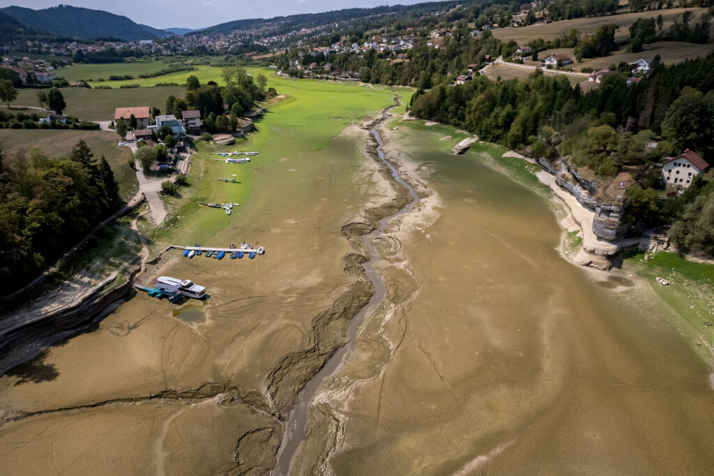 Boats are left stranded on a dried-up river on the border of France and Switzerland during a heatwave in Europe on Aug 11. Credit: Fabrice Coffrini/AFP via Getty Images