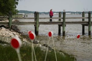 A woman stands on a pier jutting into the Chesapeake Bay near Elktonia Beach in Annapolis, Md., on May 23, 2023. Credit: Michael Robinson Chávez/The Washington Post via Getty Images