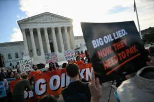 People protest in front of the Supreme Court during arguments in the Suncor v. Boulder case on Monday in Washington, D.C. Credit: Jim Watson/AFP via Getty Images
